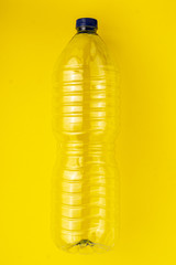 Empty plastic bottle on a yellow background
