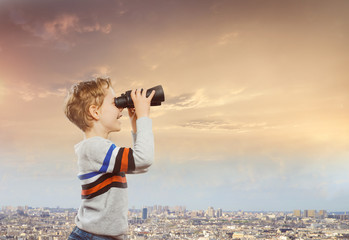 A child with binoculars  ready for getting knowledge