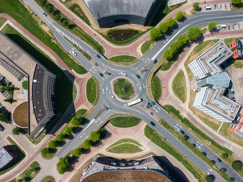 Top down aerial view of multi level turbo roundabout with road and cycle lanes in Houten, the Netherlands. Safe infrastructure solution for busy traffic intersection. 