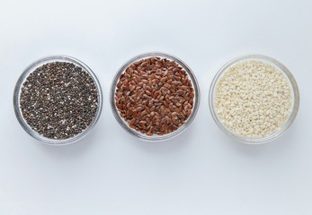 Chia, flax, sesame in glass bowls