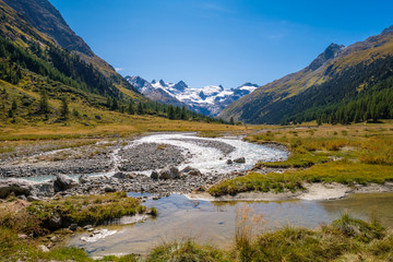 Fototapeta na wymiar Gorgeous nature of the Roseg Valley in September. It is a valley of the Swiss Alps, located on the north side of the Bernina Range in Graubünden The valley is drained by the Ova da Roseg river. 