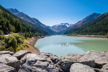 Looking at the gorgeous Gepatsch Reservoir in the Kauner Valley (Tyrol, Austria) at noon. This valley features one of the most beautiful mountain roads, the Kauner Valley Glacier Road.