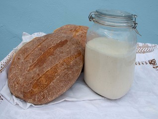 Sourdough  Bread and  starter dough  fresh baked  bread  in cottage setting 