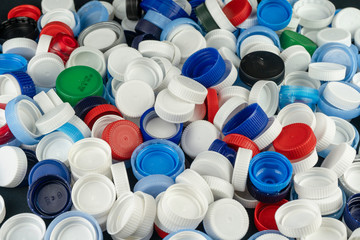 Plastic bottle caps for recycling. Recycling, solidarity and no plastic concept. Take care of the environment.  - obrazy, fototapety, plakaty