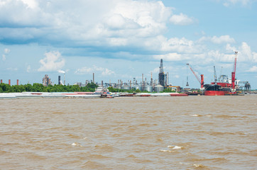 cranes loading cargo ship at new orleans refinery