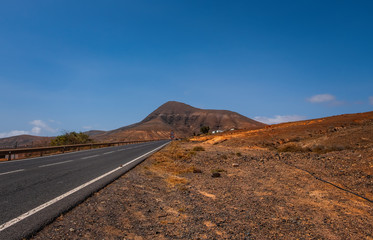 Fototapeta na wymiar The beautiful volcanic landscape in Tamariche with road on the island of Fuerteventura. Canary Islands. Spain. October 2019