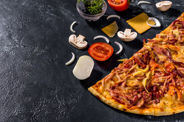 Fragrant Italian pizza. Food ingredients and spices for cooking delicious Italian pizza, mushrooms, tomatoes, cheese, onions, peppers, salt, basil, olives on a dark concrete background