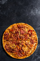 Fragrant Italian pizza. Food ingredients and spices for cooking delicious Italian pizza, mushrooms, tomatoes, cheese, onions, peppers, salt, basil, olives on a dark concrete background