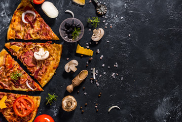 Fragrant Italian pizza. Food ingredients and spices for cooking delicious Italian pizza, mushrooms, tomatoes, cheese, onions, peppers, salt, basil, olives on a dark concrete background