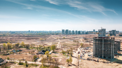 Fototapeta premium Aerial panoramic view of the construction of residential houses in the microdistricts. Space for text. Cityscape concept.
