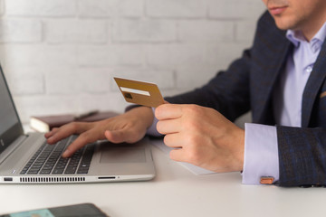 Man in an office suit drives Bank card data into the Internet