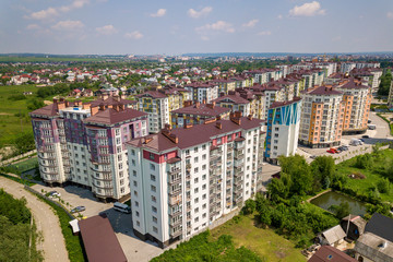Naklejka na ściany i meble Top view of apartment or office tall buildings, parked cars, urban city landscape. Drone aerial photography.