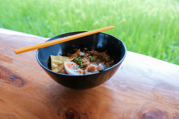Close Up noodle with chopstick on the wooden floor. Top view. Flat lay.