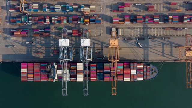 Time lapse Container , container ship in export and import business and logistics. Shipping cargo to harbor by crane. Water transport International. Aerial view and top view.