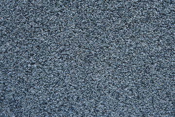 Wall made of small black and grey stones backgrounds.