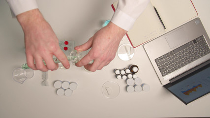 Lab technician mixes substances in a flask