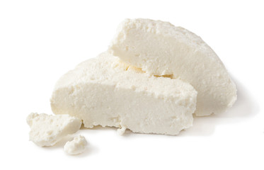 homemade Adyghe cheese cut into pieces isolated on a white background