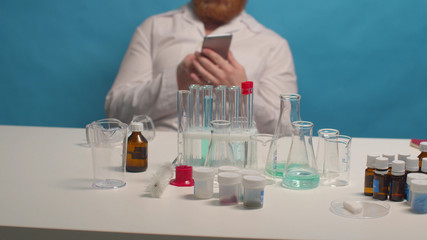 Fototapeta premium Chemist calls on the phone in the lab. Background