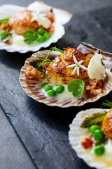Scallops with cauliflower puree, pancetta, green peas and micro herbs