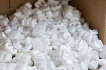 Fototapeta na wymiar Red felt heart packaging box filled with many white styrofoam pellets.