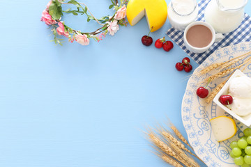 Top view photo of dairy products over pastel blue background. Symbols of jewish holiday - Shavuot