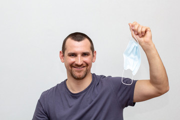 man holding in your hand medical mask to protect against COVID-19 and prevent an epidemic of a new virus