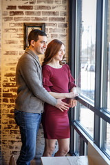 Pregnant couple in a cafe setting