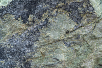 Jadeite ore texture close-up. Contains jadeite and other pyroxenes. Mineral stone surface background.