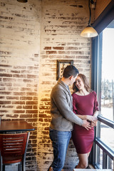 Pregnant couple in a cafe setting