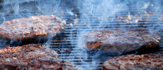 Obraz na płótnie Canvas Burgers on the grill outdoors.
