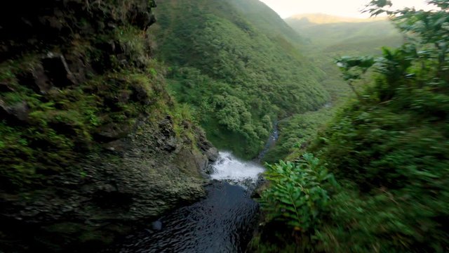 Unique Cinematic Reveal of Waterfall at Sunset in Jungle with FPV Race Drone
