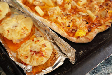 Chicken fillet with pineapples on foil and homemade Hawaiian pizza. Simple homemade recipes with pineapple