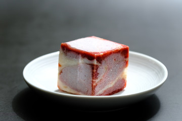 freezing raw beef cubes isolated on white plate view