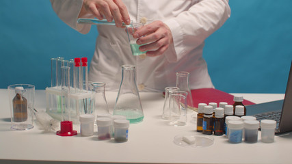 Fototapeta premium Scientist mixes alkali and acid in flasks