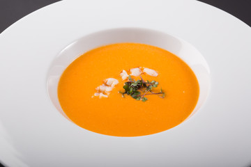 Orange pumpkin soup with prawns
