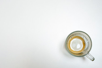 A cup of coffee with milk on the white table, Top view