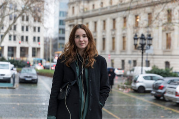 Fototapeta premium Young Urbanite Woman with Genuine Smile Posing in City