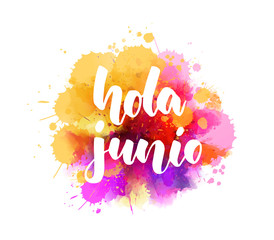 Hola Junio (Hello June in Spanish) -  handwritten modern calligraphy lettering on abstract watercolor imitation splash.