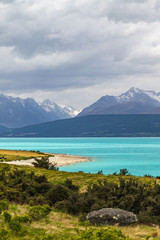 Pukaki lake. Mountains over a turquoise lake on the South Island. New Zealand