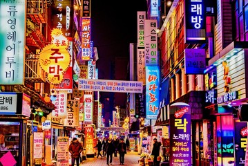 Illuminated Buildings And City Street At Night