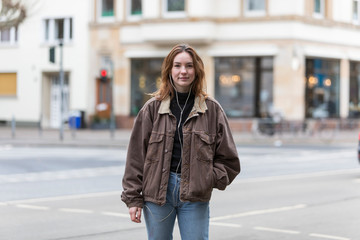 Twenty Year Old Caucasian Woman Smiling at Camera with Hand in Pocket