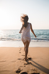 Fototapeta na wymiar woman running on the beach