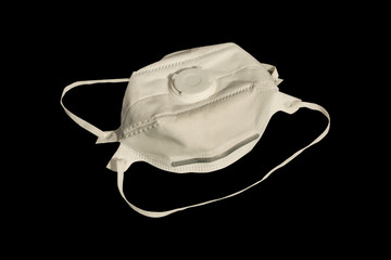 White medical mask isolated on black background. Pandemic Coronavirus Covid-19 concept
