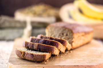 healthy, homemade vegan bread, banana flavor. Spot focus. Sliced ​​bread on rustic table.