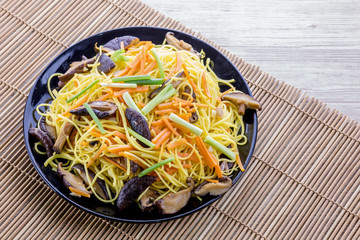Chiness noodle on black plate
