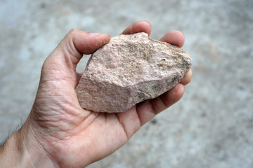 A sedimentary sandstone rock in the hand.