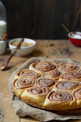 cinnamon buns on wooden table vertical
