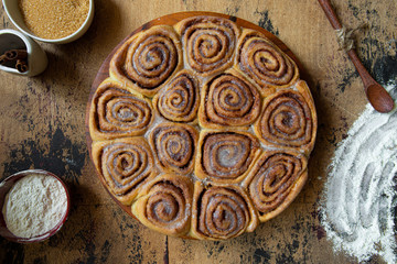 freshly baked cinnamon buns on wooden table top view