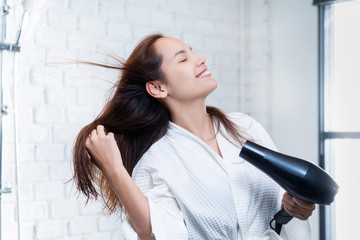 Asian woman drying your hair after showering