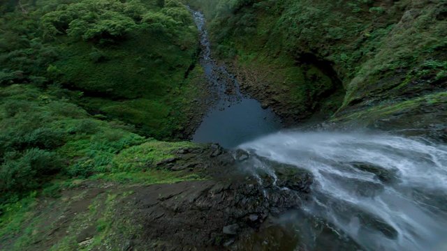 Too Close for Comfort of an FPV Race Drone Hitting Falling Water in Beautiful Green Jungle in the Wilderness